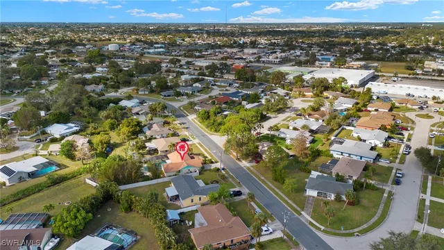 an aerial view of residential houses with outdoor space and seating