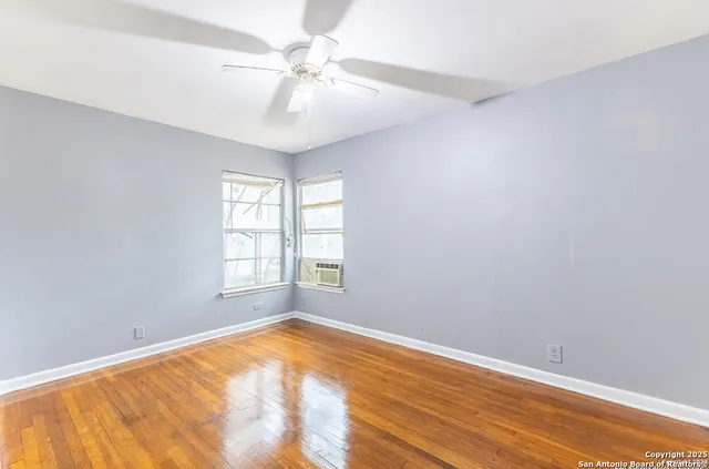wooden floor in an empty room with a window