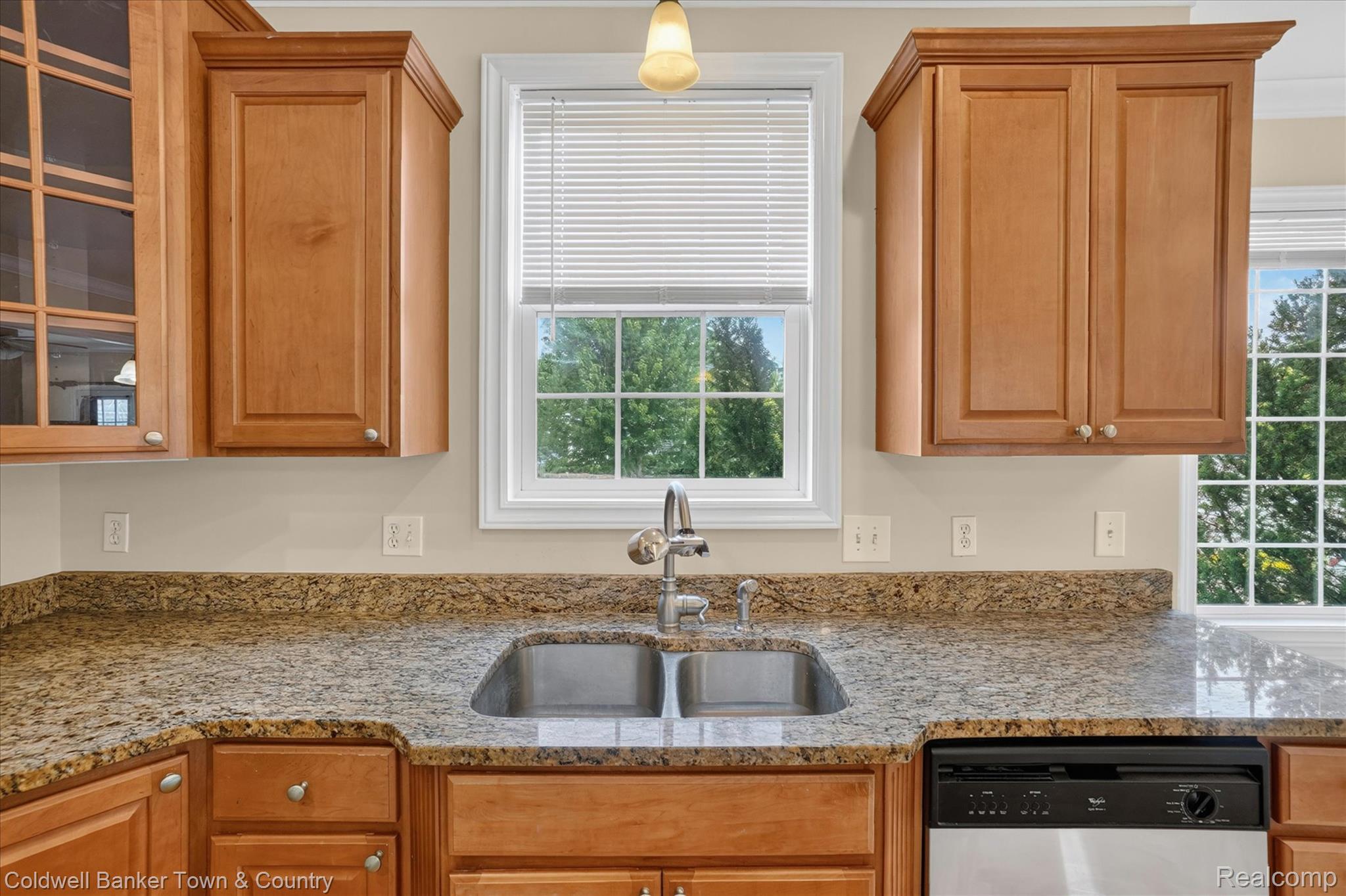 1725 Town Commons Drive Howell, MI 48855 - Photo 15 of 53 Kitchen featuring a double basin stainless steel sink, granite countertops, and light wood cabinetry