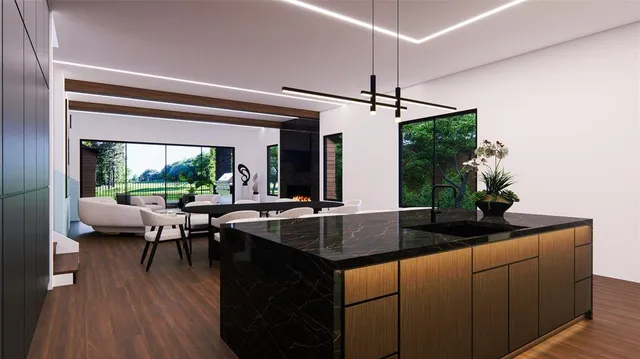 a kitchen with kitchen island granite countertop a sink and a stove