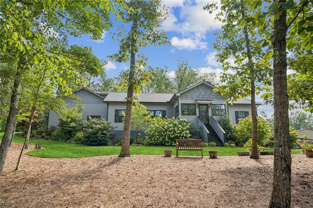 a house with green field in front of it
