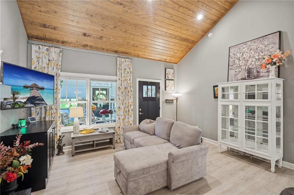 305 Wilkie Road Ball Ground, GA 30107 - Photo 12 of 37 a living room with furniture and a floor to ceiling window