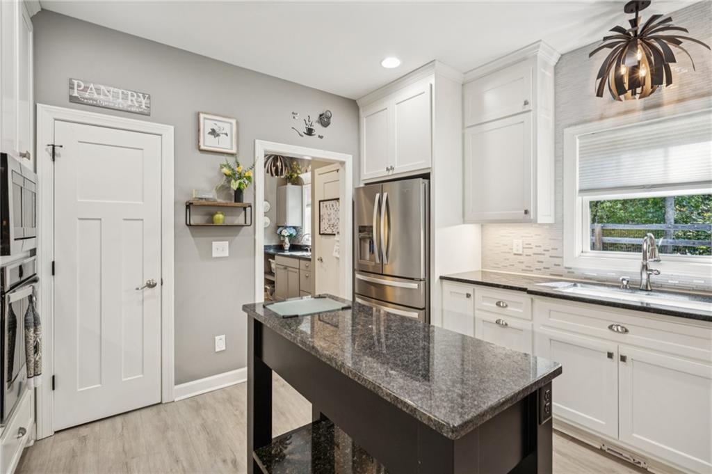 305 Wilkie Road Ball Ground, GA 30107 - Photo 15 of 37 a kitchen with stainless steel appliances granite countertop a refrigerator and a sink