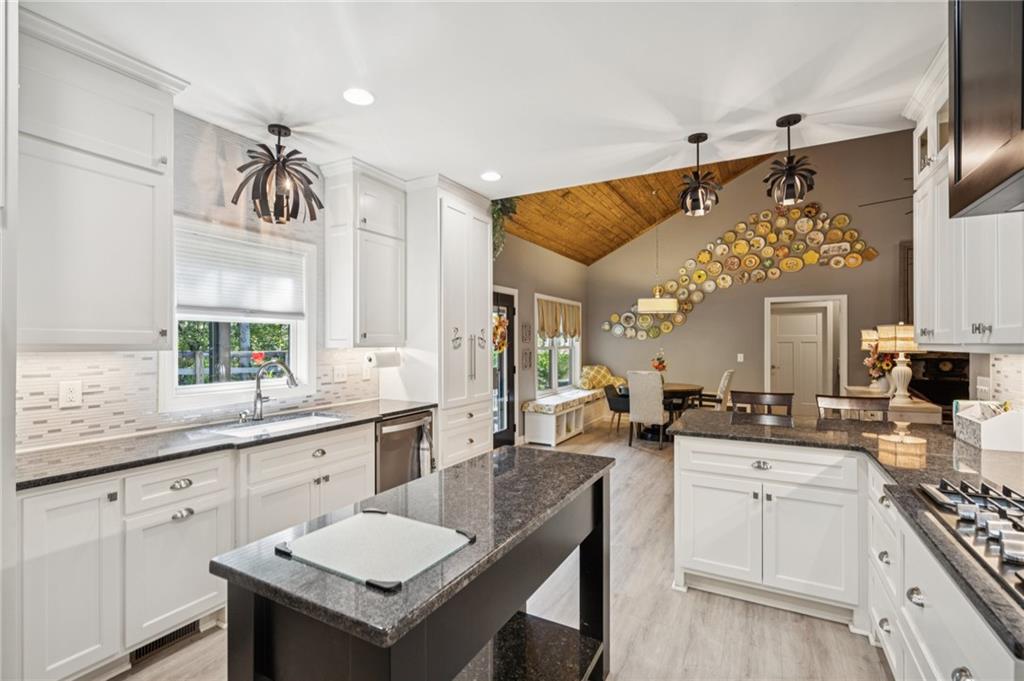 305 Wilkie Road Ball Ground, GA 30107 - Photo 16 of 37 a kitchen with a sink stove and cabinets