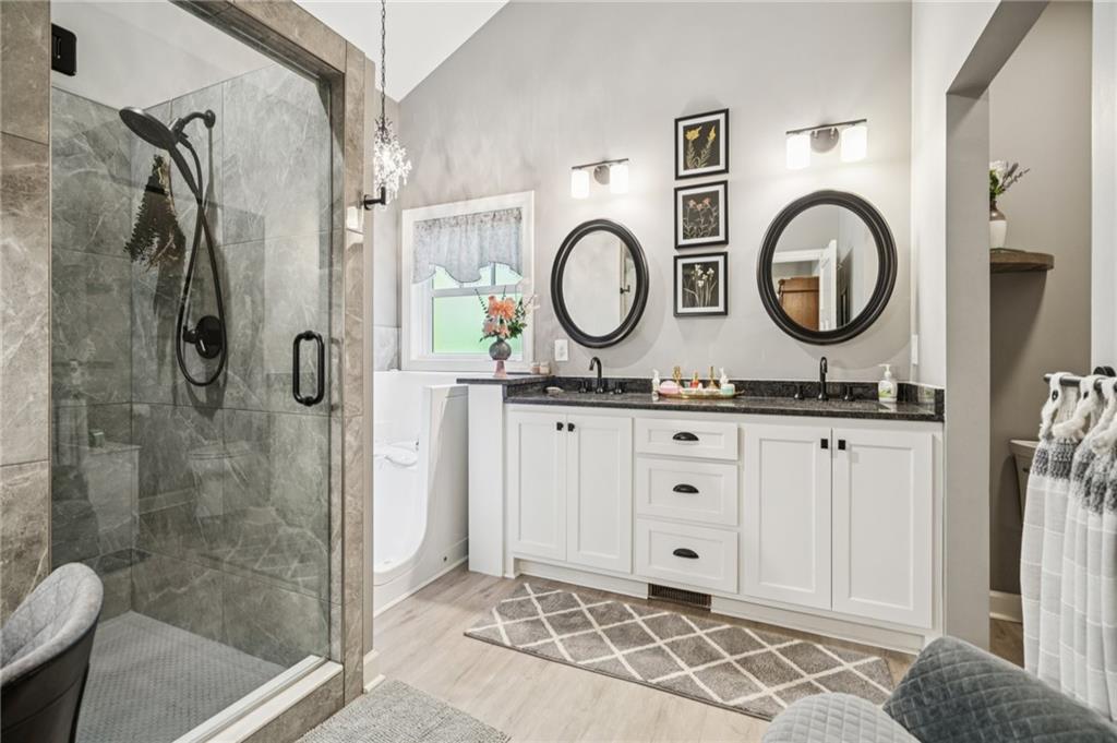 305 Wilkie Road Ball Ground, GA 30107 - Photo 20 of 37 a bathroom with a granite countertop sink and a mirror