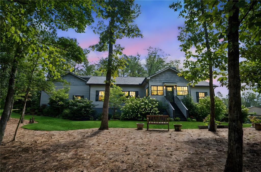 305 Wilkie Road Ball Ground, GA 30107 - Photo 2 of 37 a house with green field in front of it