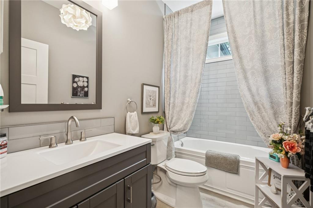 305 Wilkie Road Ball Ground, GA 30107 - Photo 22 of 37 a bathroom with a sink a toilet a mirror and shower