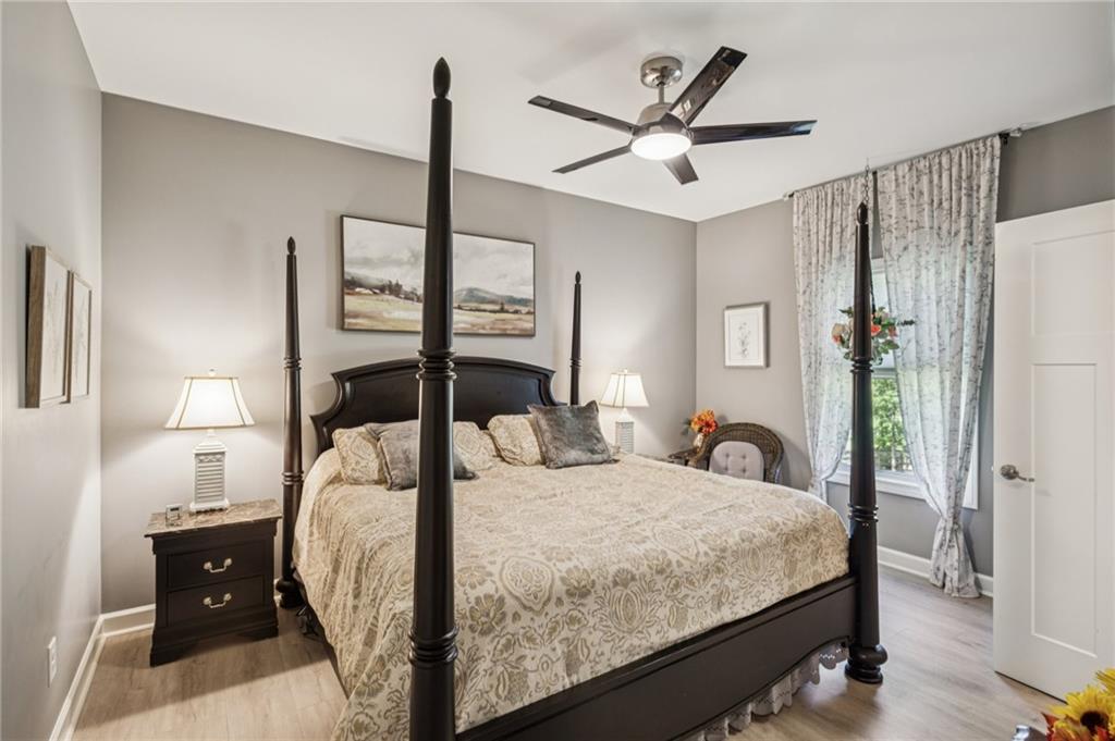 305 Wilkie Road Ball Ground, GA 30107 - Photo 23 of 37 a bedroom with a bed and a chandelier