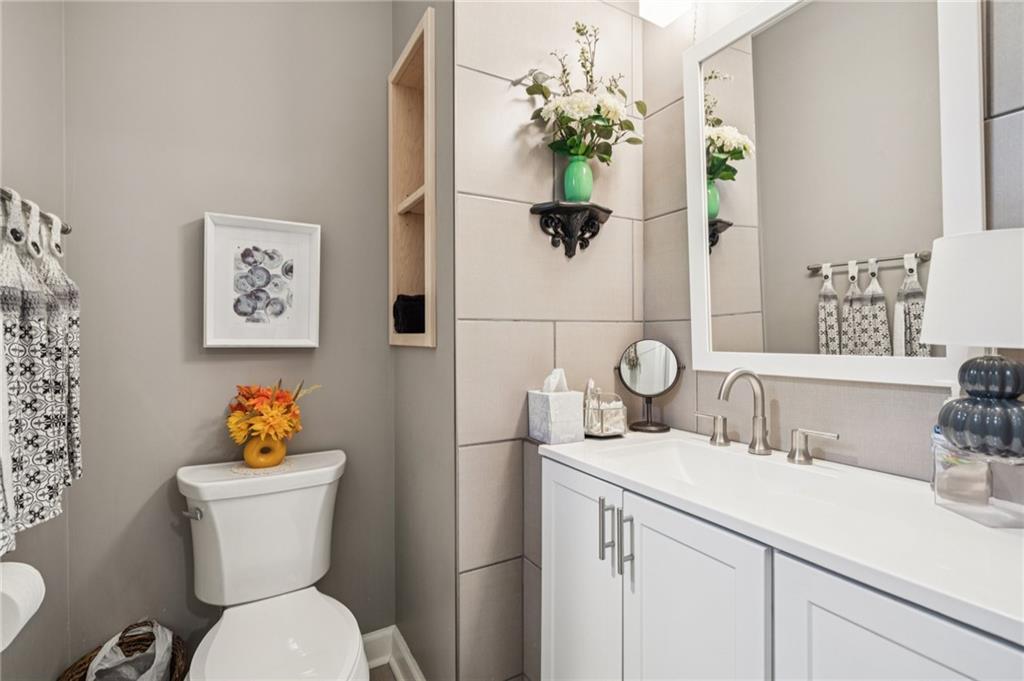 305 Wilkie Road Ball Ground, GA 30107 - Photo 24 of 37 a bathroom with a toilet sink and mirror