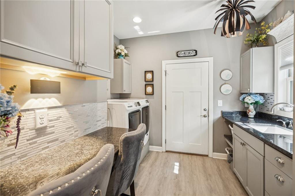 305 Wilkie Road Ball Ground, GA 30107 - Photo 26 of 37 a kitchen with a sink appliances and cabinets