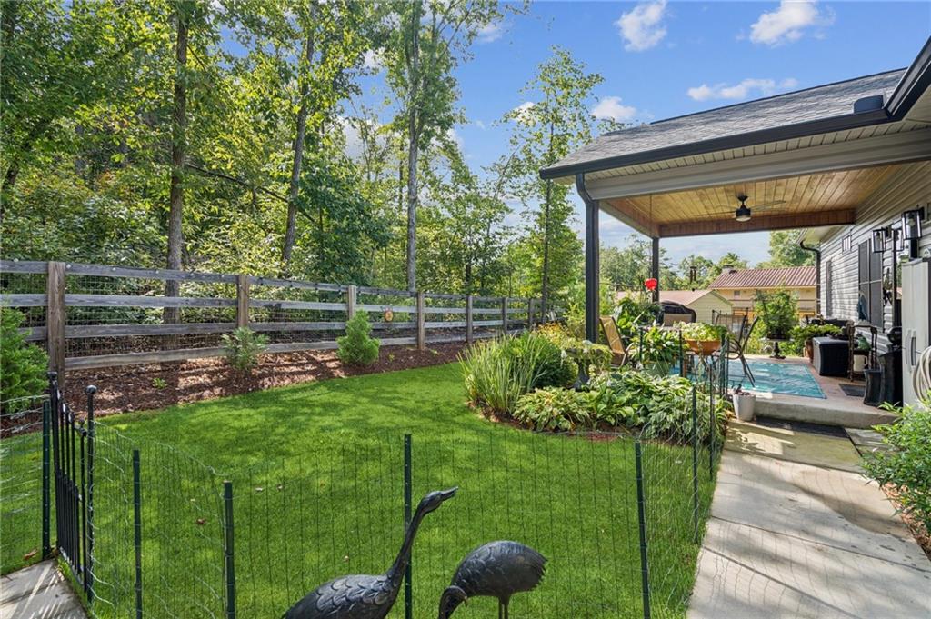 305 Wilkie Road Ball Ground, GA 30107 - Photo 28 of 37 a view of a house with a backyard