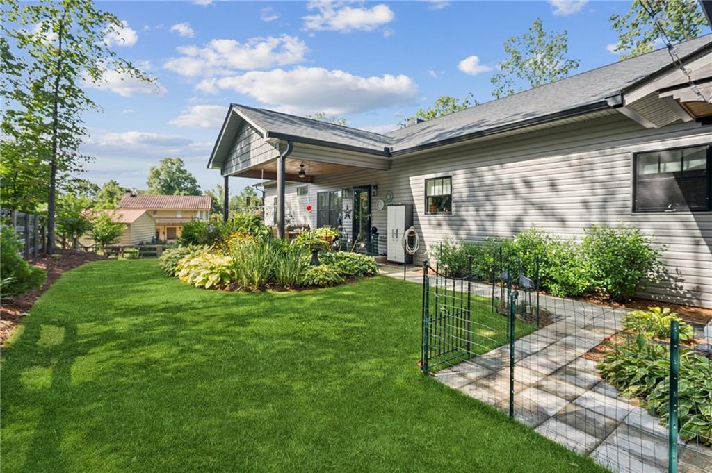 305 Wilkie Road Ball Ground, GA 30107 - Photo 29 of 37 a house view with a garden space