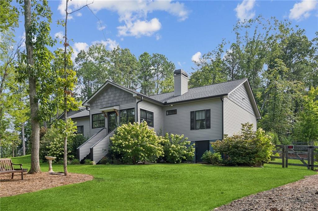 305 Wilkie Road Ball Ground, GA 30107 - Photo 3 of 37 a house with a tree in front of it