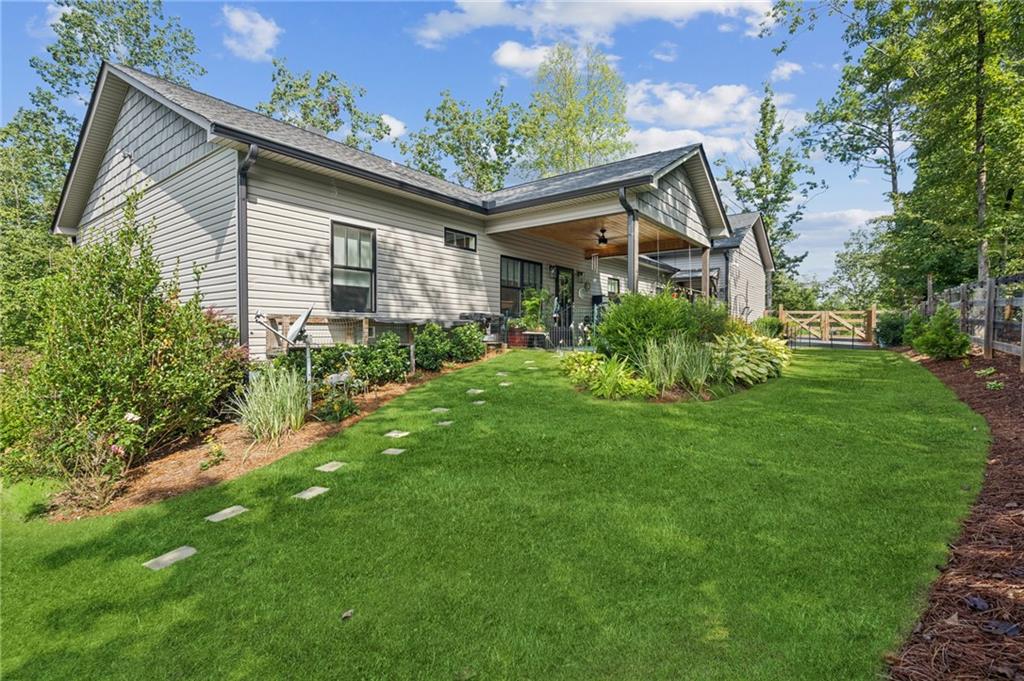 305 Wilkie Road Ball Ground, GA 30107 - Photo 32 of 37 a front view of house with yard and green space