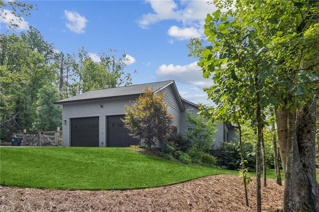 305 Wilkie Road Ball Ground, GA 30107 - Photo 4 of 37 a view of a house with a garden