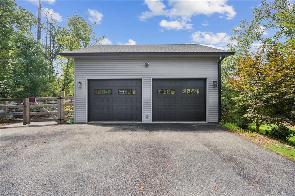 305 Wilkie Road Ball Ground, GA 30107 - Photo 6 of 37 a front view of a house with yard and garage