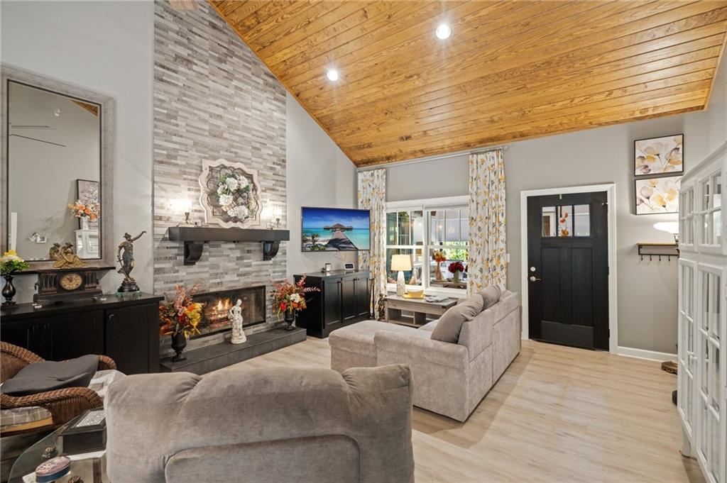 305 Wilkie Road Ball Ground, GA 30107 - Photo 9 of 37 a living room with fireplace furniture and a fireplace