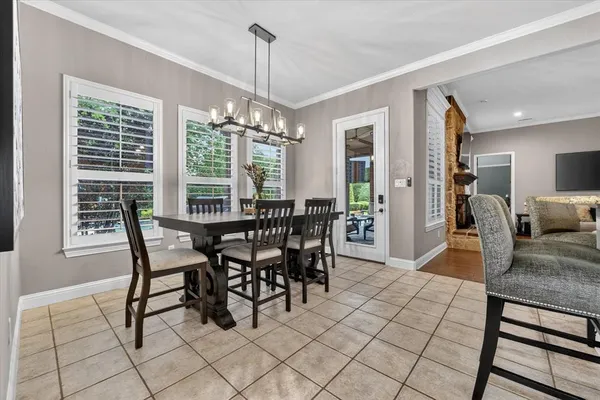 a view of a dining room with furniture wooden floor and chandelier