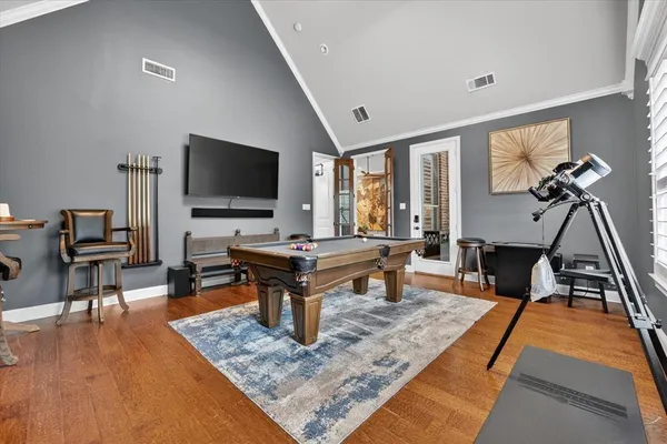 a living room with furniture a rug and a flat screen tv