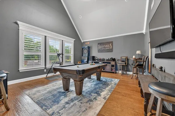 a room with pool table and windows