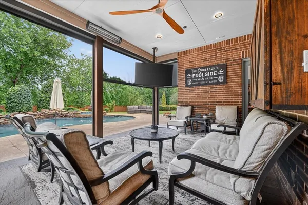 a view of a house with swimming pool and a porch with furniture