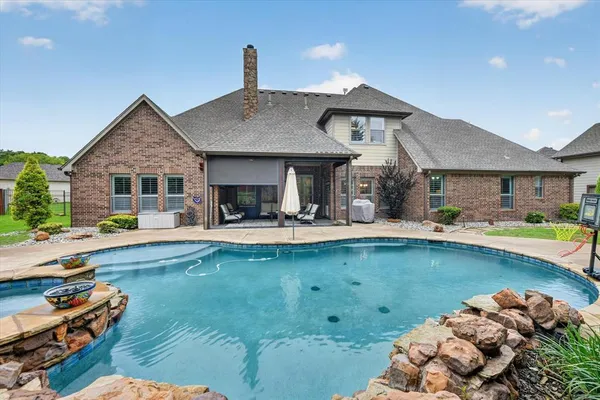 a view of house with swimming pool outdoor seating