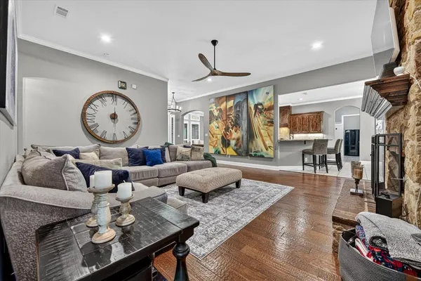 a living room with furniture a large window and a clock