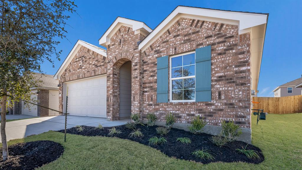 14021 Feinstein Street Manor, TX 78653 - Photo 3 of 25 A classic brick facade with blue shutters adds character to this charming front exterior.