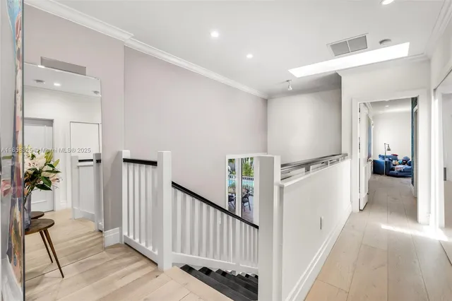 a bathroom with double vanity and a bathtub