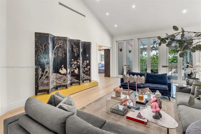 a view of a dining room with furniture and a chandelier