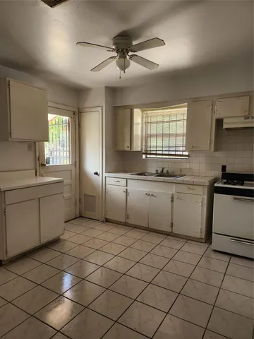 a kitchen with a sink cabinets and window