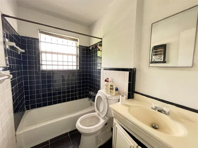 a bathroom with a sink a bathtub and shower