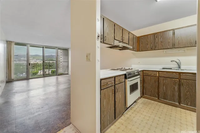 a kitchen with a sink stove and cabinets