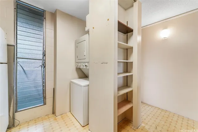 a view of kitchen with refrigerator and cabinets