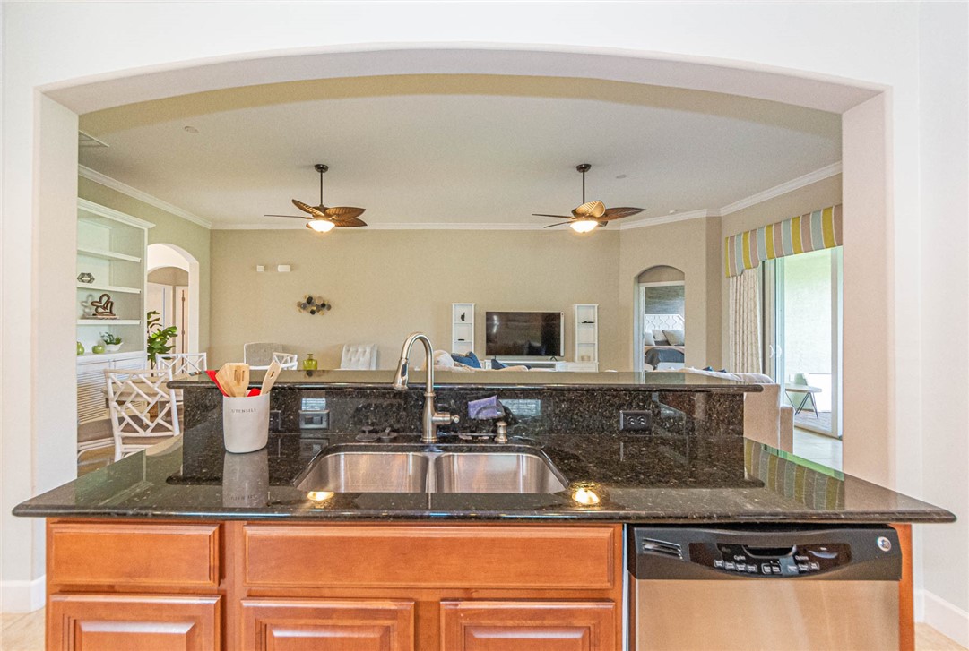 4250 Diamond Square Vero Beach, FL 32967 - Photo 12 of 33 a kitchen with kitchen island granite countertop a sink stainless steel appliances and cabinets
