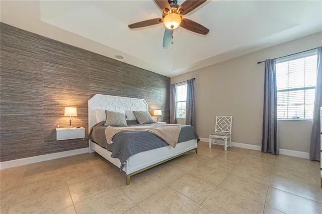 a bedroom with a bed chair and window