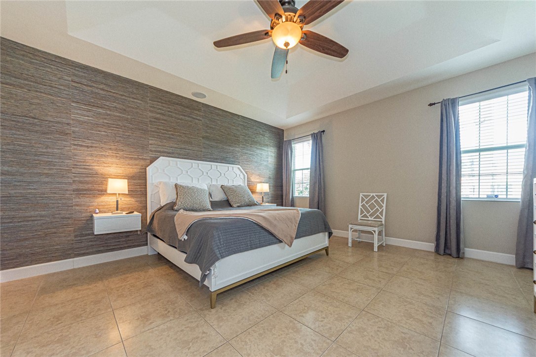 4250 Diamond Square Vero Beach, FL 32967 - Photo 17 of 33 a bedroom with a bed chair and window