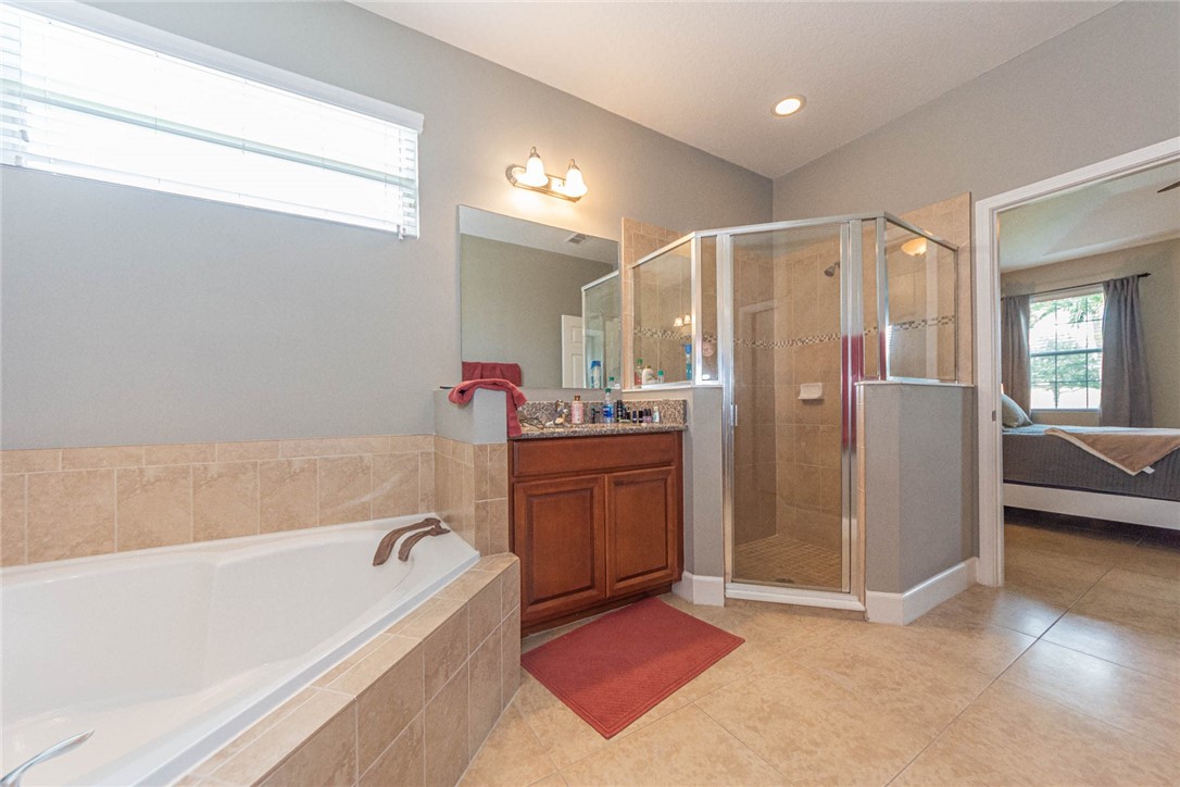 4250 Diamond Square Vero Beach, FL 32967 - Photo 21 of 33 a bathroom with a tub shower and sink