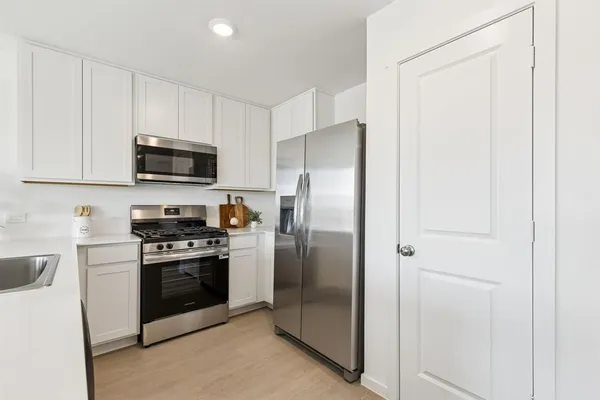 a kitchen with a refrigerator stove and microwave
