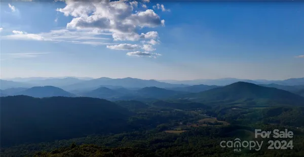 a view of a house with a mountain in the background