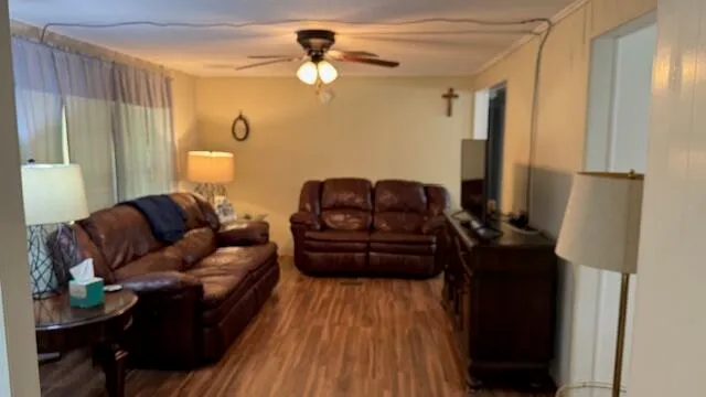 a living room with furniture and a wooden floor