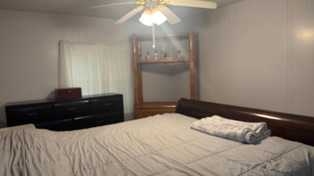7148 Southeast Seahawk Street Hobe Sound, FL 33455 - Photo 15 of 28 a bedroom with a bed and window