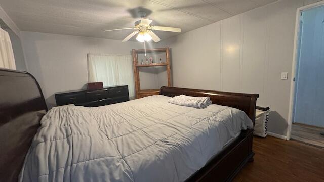 7148 Southeast Seahawk Street Hobe Sound, FL 33455 - Photo 16 of 28 a bedroom with a bed and a chandelier