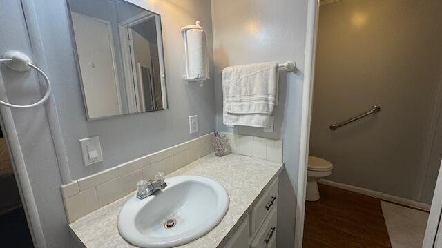7148 Southeast Seahawk Street Hobe Sound, FL 33455 - Photo 17 of 28 a bathroom with a sink toilet and vanity