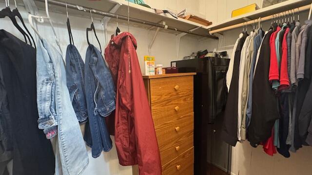 7148 Southeast Seahawk Street Hobe Sound, FL 33455 - Photo 20 of 28 a view of walk in closet with clothes and shoes