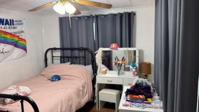 7148 Southeast Seahawk Street Hobe Sound, FL 33455 - Photo 25 of 28 a bedroom with furniture and a bed