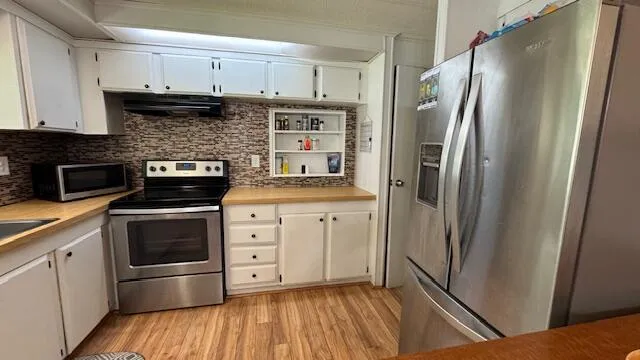 a kitchen with a refrigerator sink and stove