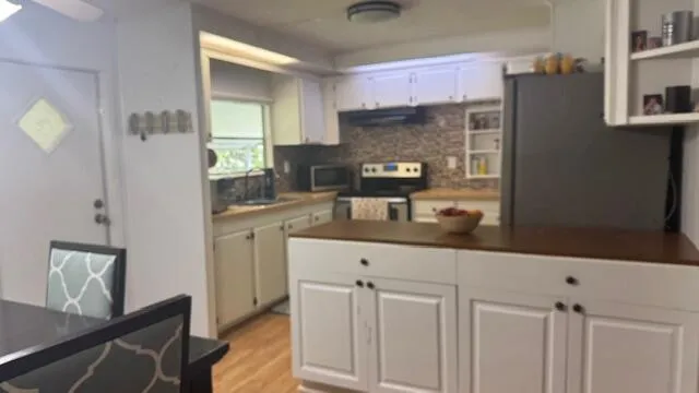 a kitchen with cabinets and window