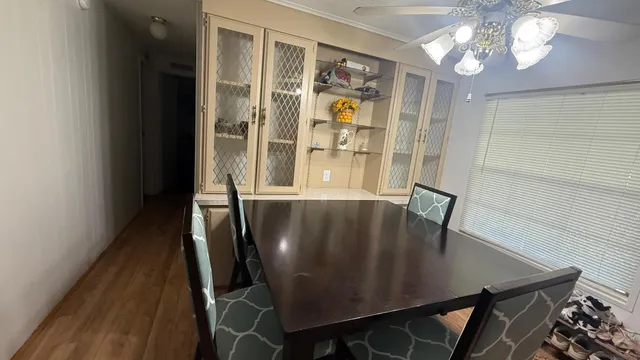 a view of a dining room with furniture and a chandelier