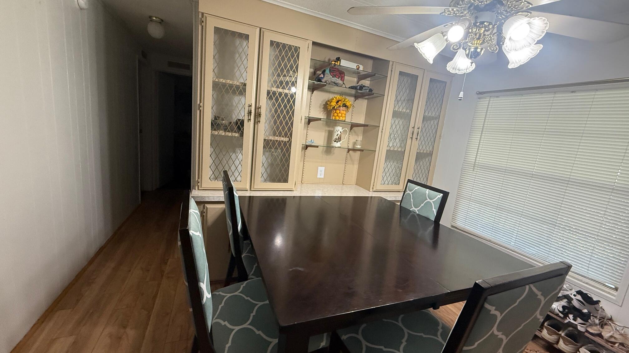 7148 Southeast Seahawk Street Hobe Sound, FL 33455 - Photo 6 of 28 a view of a dining room with furniture and a chandelier